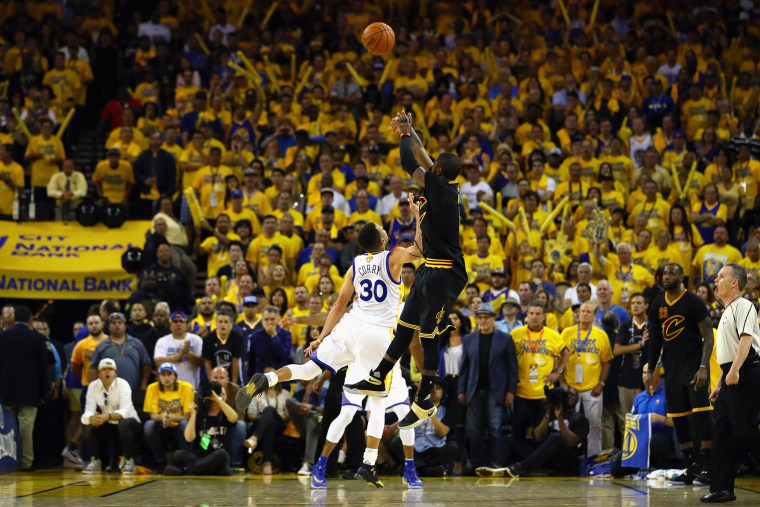 Kyrie Irving #2 of the Cleveland Cavaliers shoots a three-point basket late in the fourth quarter against Stephen Curry #30 of the Golden State Warriors in Game 7 of the 2016 NBA Finals at ORACLE Arena on June 19, 2016 in Oakland, Calif. (Ezra Shaw/Getty)
