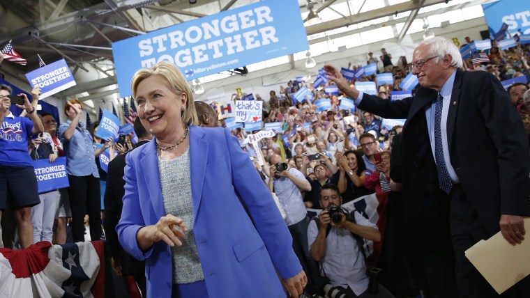 Democratic presidential candidate Hillary Clinton, followed by Sen. Bernie Sanders, I-Vt. arrives for a rally in Portsmouth, N.H., July 12, 2016. (Photo by Andrew Harnik/AP)