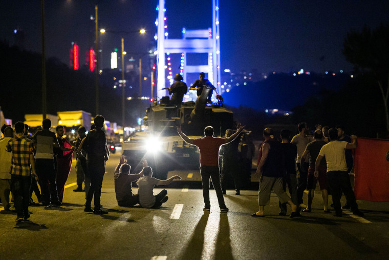 People take over a tank near the Fatih Sultan Mehmet bridge during clashes with military forces in Istanbul on July 16, 2016. (Photo by Gurkan Ozturk/AFP/Getty)