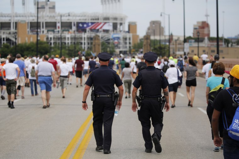 Police officers walk among people marching to join hands in a peace rally amid preparations for the arrival of visitors and delegates for the Republican National Convention on July 17, 2016, in Cleveland, Ohio. (Photo by Dominick Reuter/AFP/Getty)
