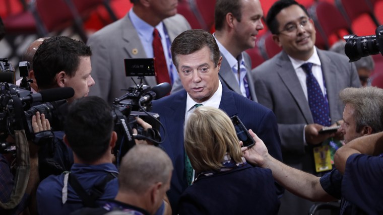 Trump Campaign Chairman Paul Manafort is surrounded by reporters on the floor of the Republican National Convention in Cleveland. (Photo by J. Scott Applewhite/AP)