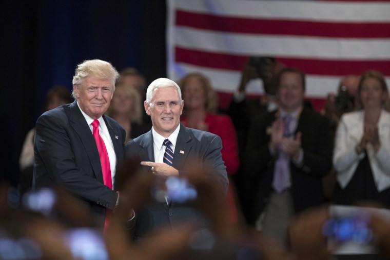 Republican presidential candidate Donald Trump, left, shakes hands with vice presidential candidate Gov. Mike Pence, R-Ind., during a town hall, July 25, 2016, in Roanoke, Va. (Photo by Evan Vucci/AP)