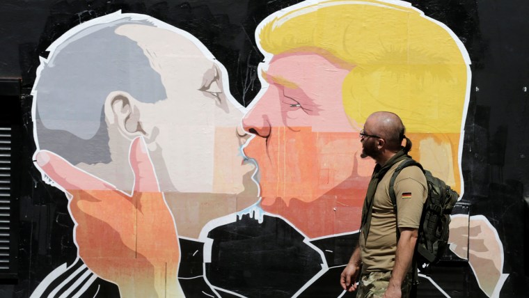 A man walks past a graffiti depicting Republican presidential Donald Trump and Russia's President Vladimir Putin in Vilnius, Lithuania, June 1, 2016. (Photo by Ints Kalnins/Reuters)