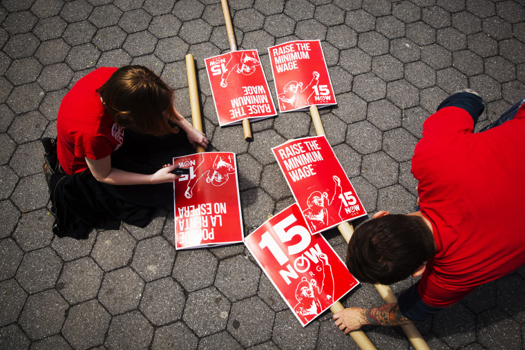 Demonstrators prepare signs supporting the raising of the federal minimum wage during May Day demonstrations, May 1, 2014, in New York. (Photo by Lucas Jackson/Reuters)