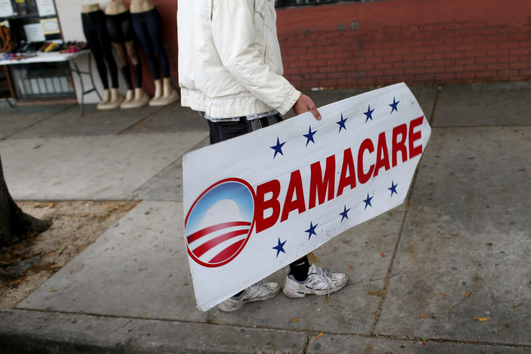 Pedro Rojas holds a sign directing people to an insurance company where they can sign up for the Affordable Care Act, also known as Obamacare, before the February 15th deadline on Feb. 5, 2015 in Miami, Fla.  (Joe Raedle/Getty)