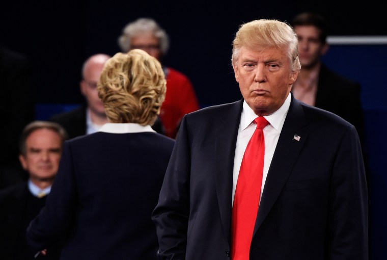Democratic presidential nominee Hillary Clinton and Republican presidential nominee Donald Trump listen to a question during the town hall debate at Washington University on Oct 9, 2016 in St Louis, Mo. (Photo by Saul Loeb/Pool/Getty)