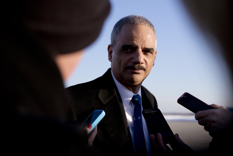 Then, Attorney General Eric Holder talks with media as he arrives on Air Force One in Andrews Air Force Base, Md., on March 6, 2015. (Photo by Carolyn Kaster/AP)