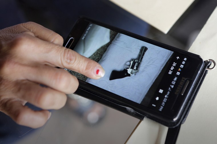 A Los Tules hotel staff member shows a photo taken with her phone of a gun found in a room where Ethan and Tonya Couch stayed for five days in the Pacific beach resort of Puerto Vallarta, Mexico, Dec. 30, 2015. (Photo by Henry Romero/Reuters)