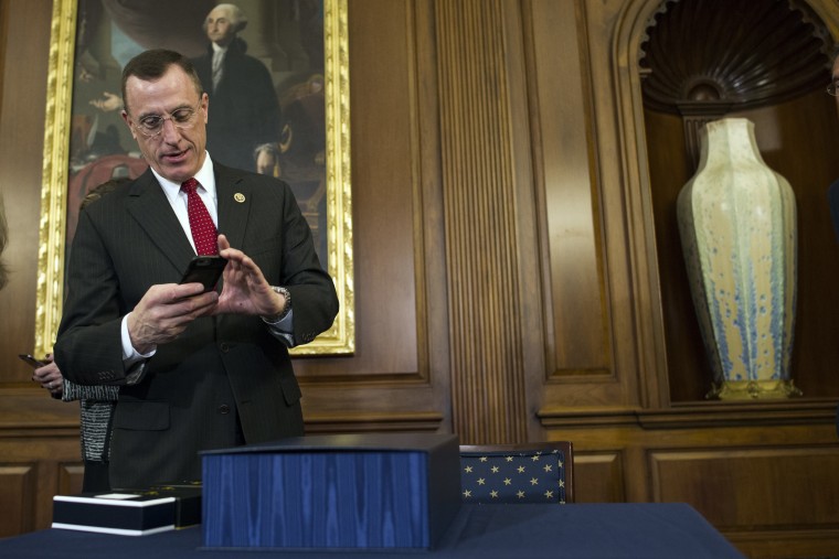 Rep. Tim Murphy, R-Pa., take a photo of the 21st Century Cures Act prior to a signing ceremony on Capitol Hill in Washington, Thursday, Dec. 8, 2016.