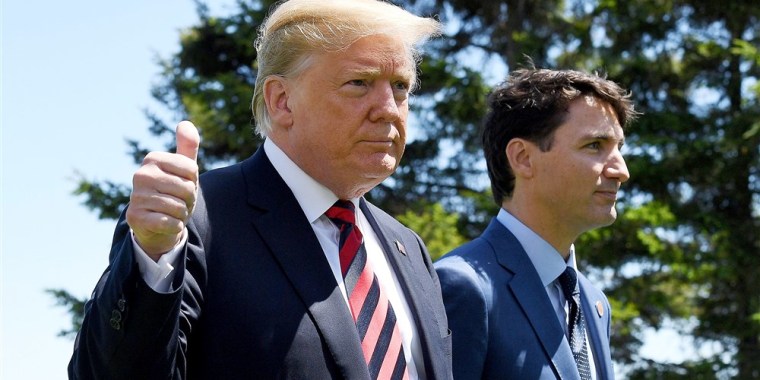U.S. President Donald Trump gives a thumbs up to the media as he is greeted by Prime Minister of Canada Justin Trudeau during the G7 official welcome at Le Manoir Richelieu on day one of the G7 meeting on June 8, 2018 in Quebec City, Canada. Leon Neal / Getty Images