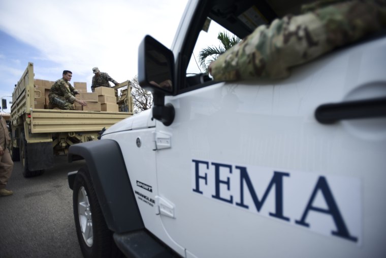 In this Oct. 5, 2017 file photo, Department of Homeland Security personnel deliver supplies to Santa Ana community residents in the aftermath of Hurricane Maria in Guayama, Puerto Rico.