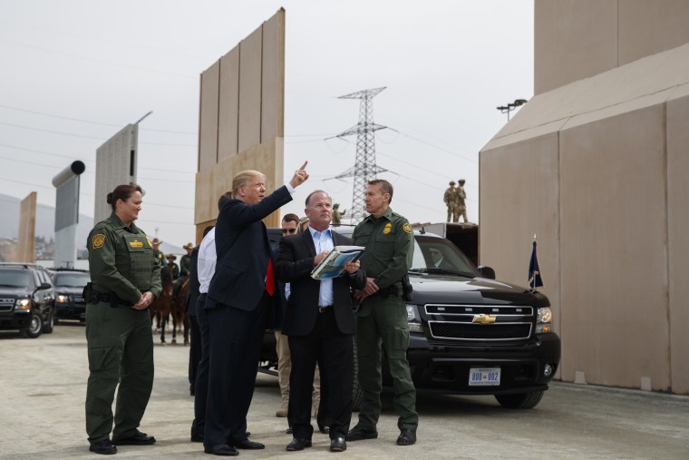 President Donald Trump reviews border wall prototypes, Tuesday, March 13, 2018, in San Diego.