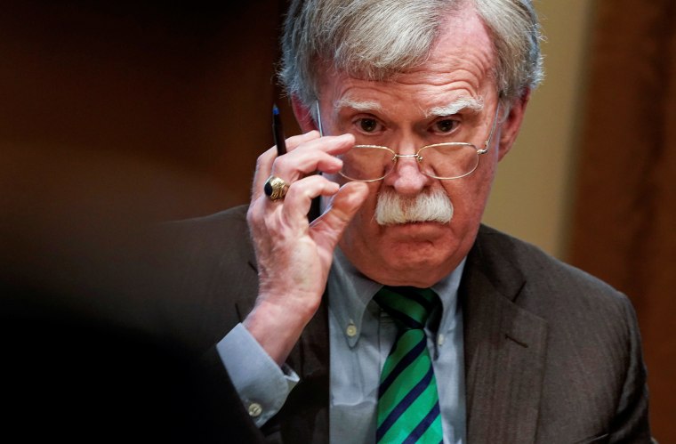 National Security Advisor John Bolton adjusts his glasses as U.S. President Donald Trump speaks while meeting with NATO Secretary General Jens Stoltenberg in the Oval Office at the White House in Washington, U.S., April 2, 2019.