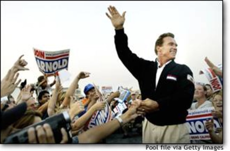 Arnold Schwarzenegger greets supporters during a rally in San Bernardino, Calif.
