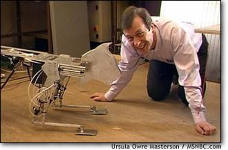 In a picture taken before his latest implant, University of Reading Professor Kevin Warwick plays with his robotic cat, Hissing Sid.