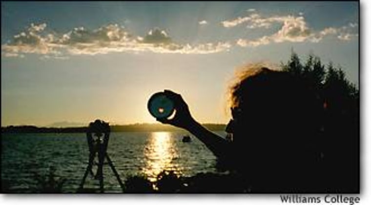 An observer holds up a solar filter to get a safe view of the partial eclipse that was visible from Seattle in July 2000.