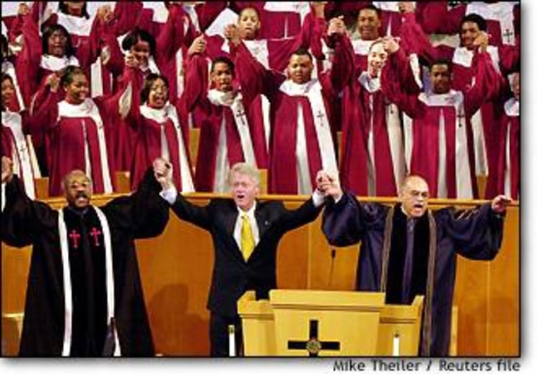 President Bill Clinton sings with the clergy and choir of the Alfred Street Baptist Church in Alexandria, Va., last October.