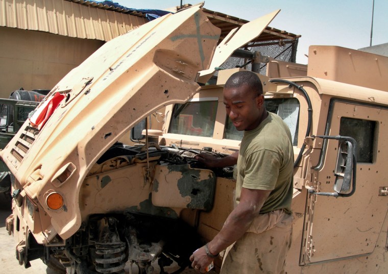 U.S. Marine reservist Sgt. Recordo Demetrius of Garden City, N.Y., repairs a Humvee damaged by a roadside bomb in Fallujah, west of Baghdad, Iraq, in this June 10 photo. With the war in Iraq still raging and the full-time military stretched thin, the Pentagon is counting on volunteers to fill the gap. 