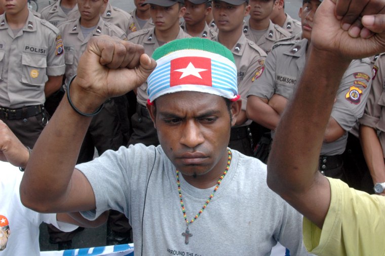 A Papuan protester wearing a headband  with the banned separatist "Morning Star" flag raises his fist during a pro-independence demonstration in Yogyakarta on Wednesday.  