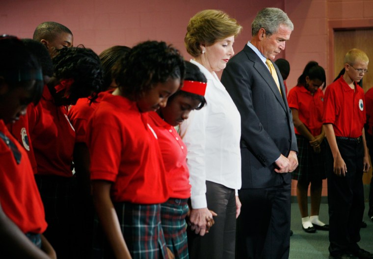 U.S. President George W. Bush and first lady Laura Bush take part in a moment of silence marking the second anniversary of Hurricane Katrina at Dr. Martin Luther King, Jr. Charter School for Science and Technology in New Orleans, Louisiana