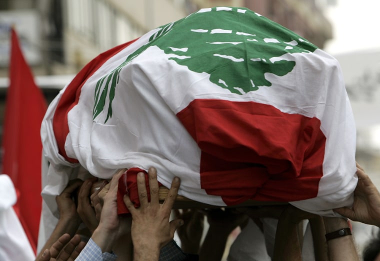 Relatives and colleagues carry the coffin, draped with the Lebanese flag, of the anti-Syrian Lebanese lawmaker Antoine Ghanem, who was killed on Wednesday by a powerful bomb, on Friday. 