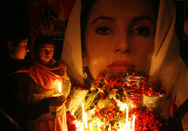 Image: Supporters of Benazir Bhutto hold candles during a homage ceremony.