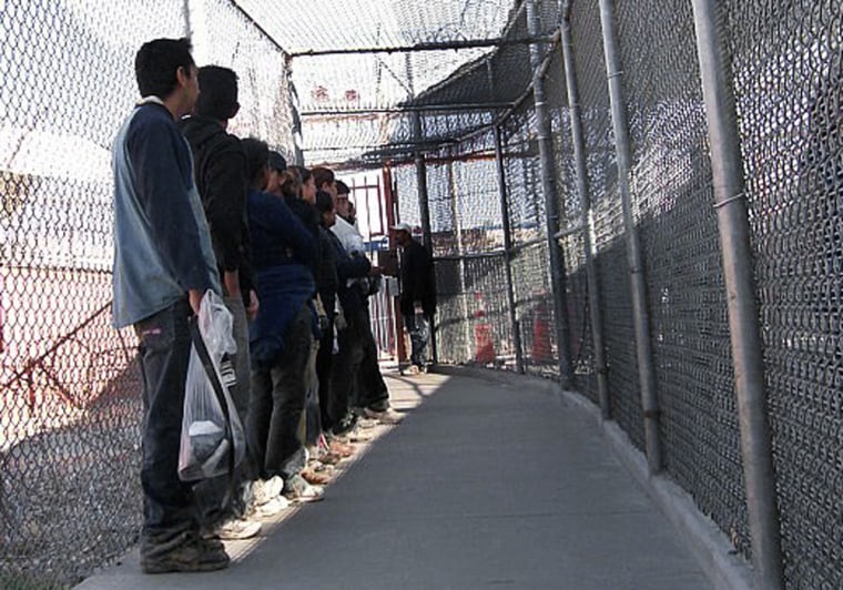Image: Illegal immigrants from Mexico wait in a holding area in El Paso, Texas