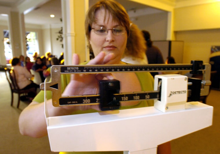 Image: Jamie Wright checks her weight loss