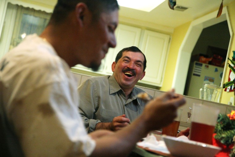 Francisco Ramirez, who originally entered the United States illegally years ago but who now has a green card, dines with Jose Angel Fuentes at Ramirez's home in Herndon, Va.