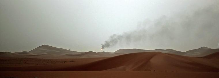 Image: A trail of smoke rises from the flame at the Saudi Aramco (the national oil company) oil installation known as \"Pump 3\"
