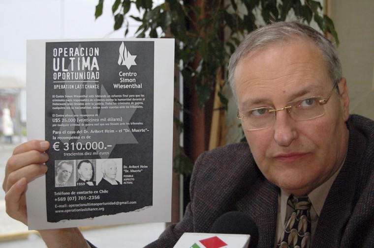 Image:  he chief of the Simon Wiesenthal Center's Israeli office, historian and top Nazi hunter Efraim Zuroff, shows a reward poster