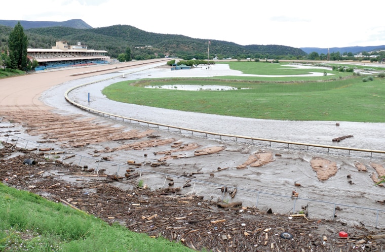 This photo provided by Ruidoso News shows the damage caused by flooding at the Ruidoso Downs Racetrack in Ruidoso Downs, N.M. on July 27, 2008. An attempt by Peppers Pride, a New Mexico mare, to go for a record 17 victories in 17 starts was delayed after the flooded track forced Ruidoso Downs to cancel Sunday's races. About 300 people were evacuated from homes, campgrounds and a recreational vehicle park as flooding hit around the resort town of Ruidoso, after the remnants of Hurricane Dolly dumped an estimated six inches on the mountainous area. (AP Photo/Mike Curran, Ruidoso News) **NO SALES**