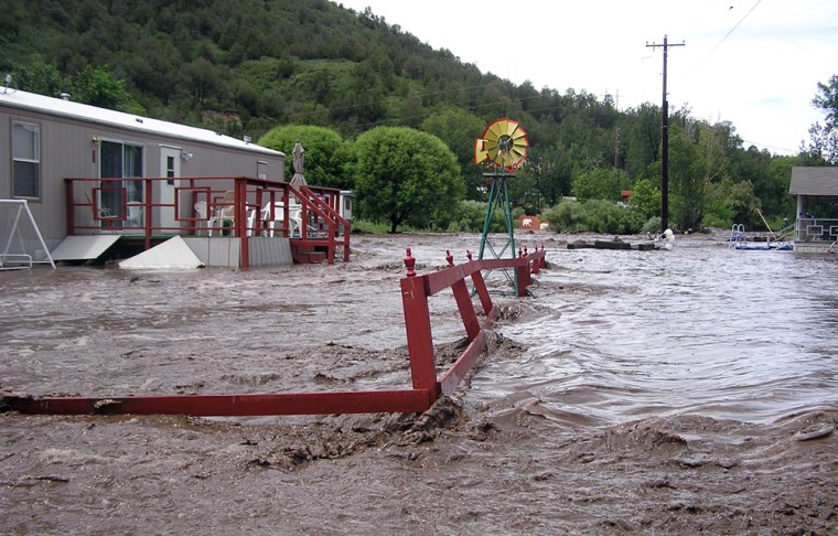 Floodwaters destroy yards and fences at River Ranch RV Park, along Highway 70 between Glencoe and Ruidoso Downs, N.M. on Sunday. The remnants of Hurricane Dolly dumped an estimated six inches of rain on the mountainous area.