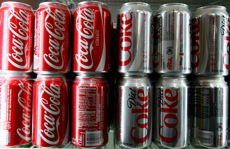 Image: Coca-Cola cans are seen in a convenience store.