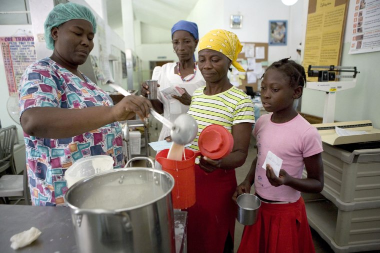 Relatives of malnourished children receive free milk at the Albert Schweitzer hospital in Deschapelles, Haiti, Tuesday, June 17, 2008. Funding delays, a dysfunctional central government and transportation problems along crumbling rural roads are keeping aid from reaching critical areas such as the fertile Artibonite Valley, where one out of three children are malnourished. (AP Photo/Ariana Cubillos)