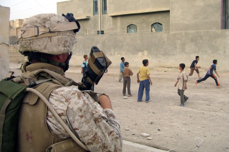 Image: A U.S. marine watches children play in Ramadi, Iraq