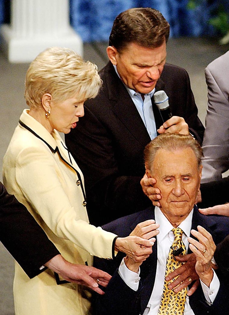 Image: In this June 18, 2008 file photo, televangelist Gloria Copeland and Kenneth Copeland lay hands on Oral Roberts