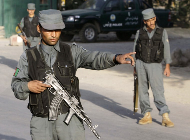 Image: Armed police stand guard in a street in Kabul, Afghanistan,