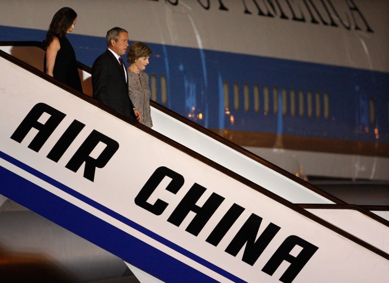 Image: U.S. President George W. Bush, first lady Laura Bush and their daughter Barbara arrive at Beijing Capital International Airport