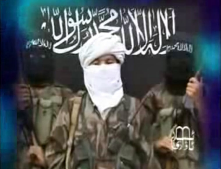 Image: A frame from a video purportedly from the Turkistan Islamic Party (TIP), taken from the Internet, shows a man speaks in front of a black banner