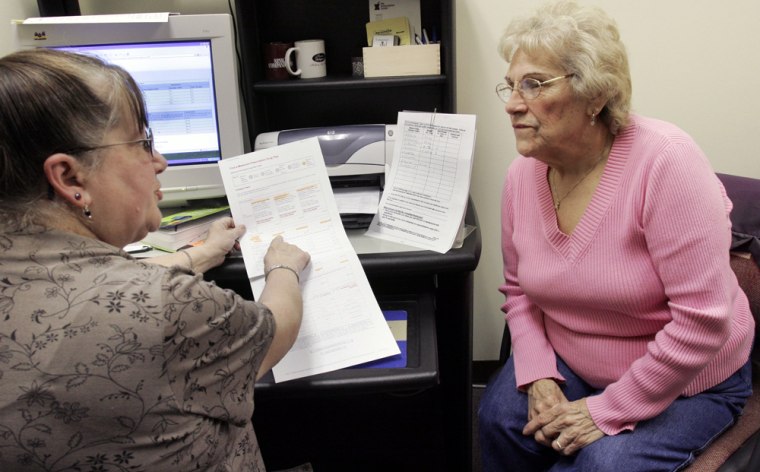 Image: A volunteer counsels a medicare recipient about her plan