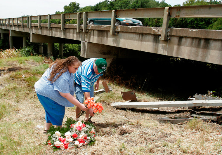 April and Brian McCandless of Haltom City, Texas, on Saturday place flowers at the bridge where the crash occurred a day earlier.