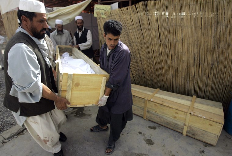 Image: Afghan paramedical staff carry the body of a foreign aid worker