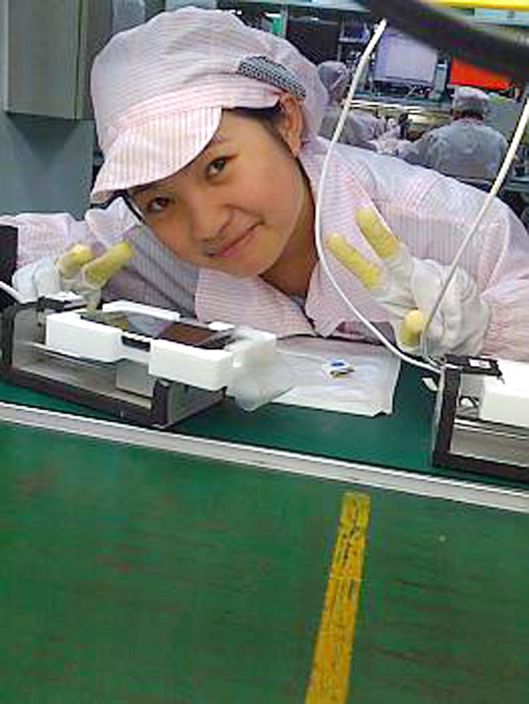 Image: Chinese technician poses at an iPhone assembly plant