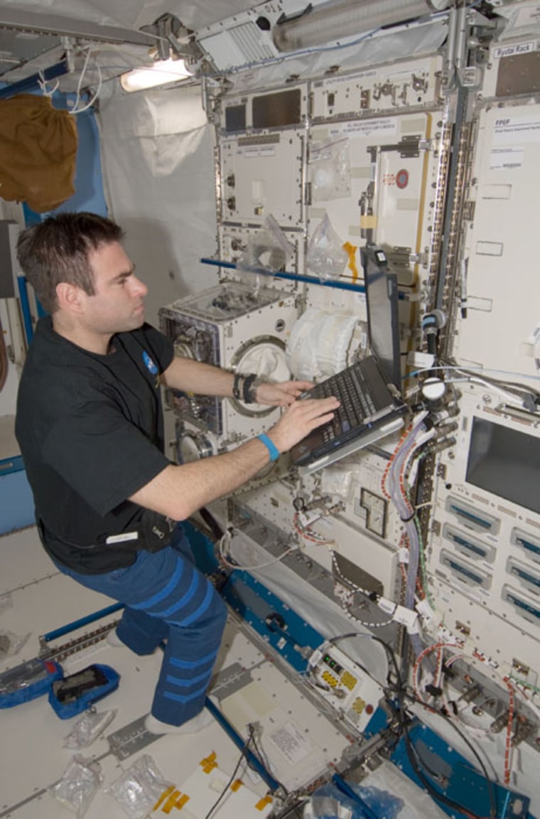 Image: Chamitoff and computer on space station