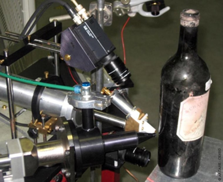 A particle accelerator’s ion beams are focused on a wine bottle to determine the age of the bottle’s glass, which provides a date for the vintage of the wine inside.
