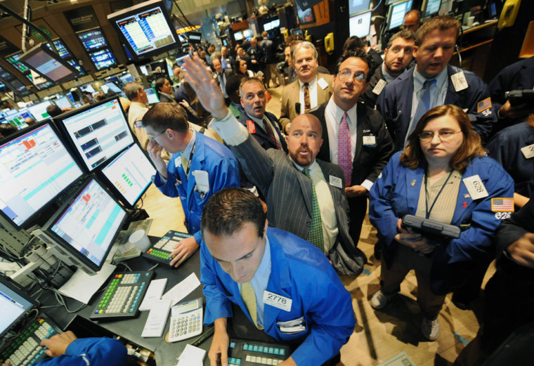 Image: Traders work on the floor of the New York Stock Exchange