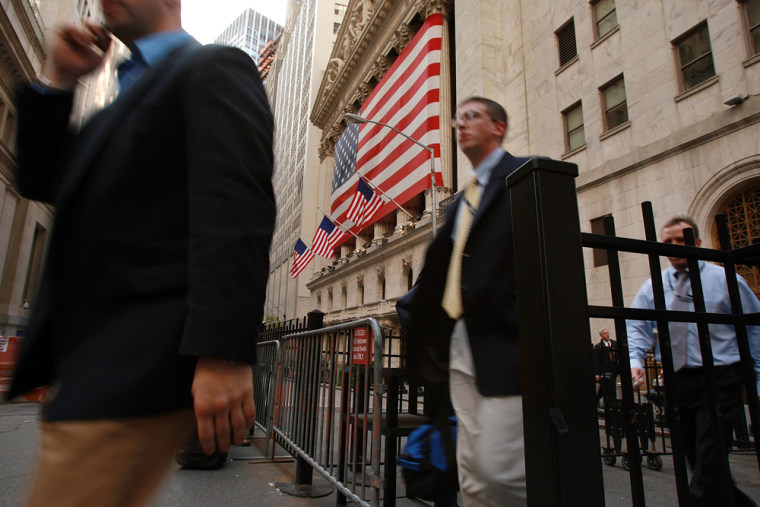 Image:  Employees leave the New York Stock Exchange