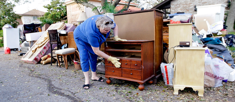 Image: Galveston resident going through damaged furniture