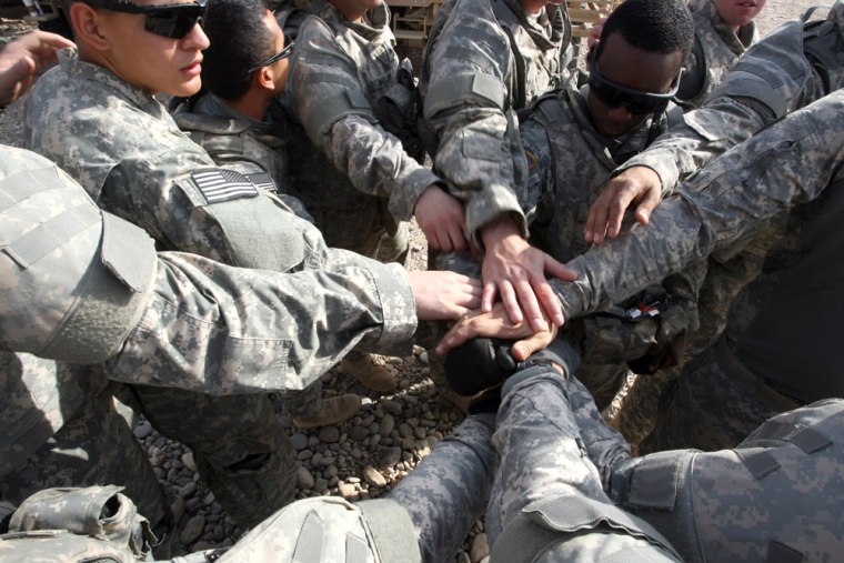 U.S. soldiers touch hands prior to going on patrol to the northern Iraqi city of Tikrit on September 11, 2008. 